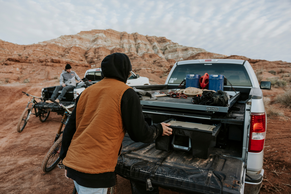 Pickup truck with organized DECKED storage in a desert landscape