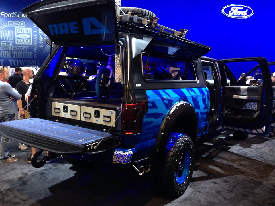 Pickup truck fitted with an A.R.E. cap and organized bed storage